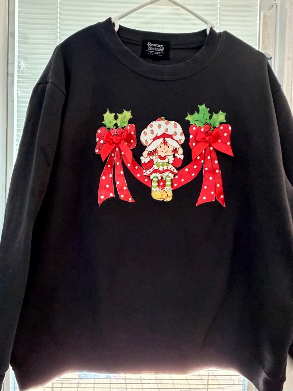 Strawberry Shortcake Black Holiday Sweatshirt with Festive Bow Graphic